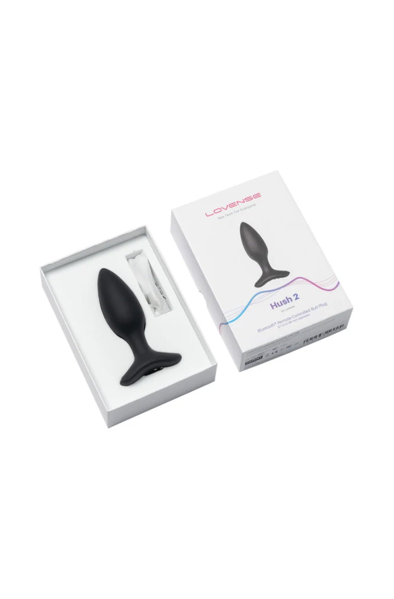Open white box showing black butt plug in foam insert with magnetic charging cable