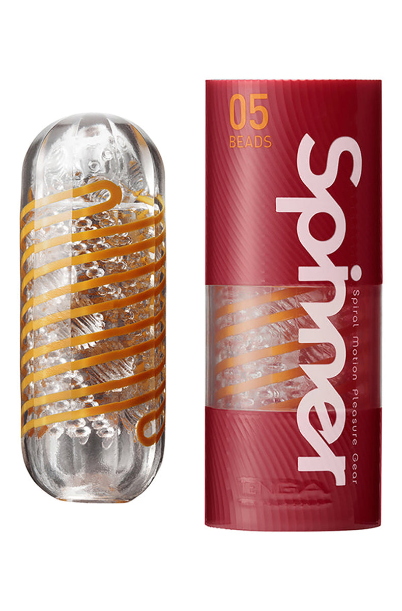 Tenga Spinner Beads sleeve with orange spiral cord inside clear case next to red tube box
