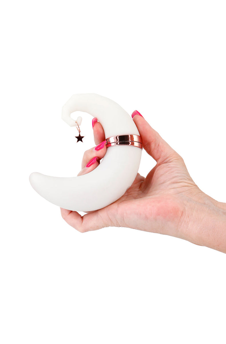 Back view of Firefly Dream crescent moon shaped silicone air pulse vibrator on a white cloud base.