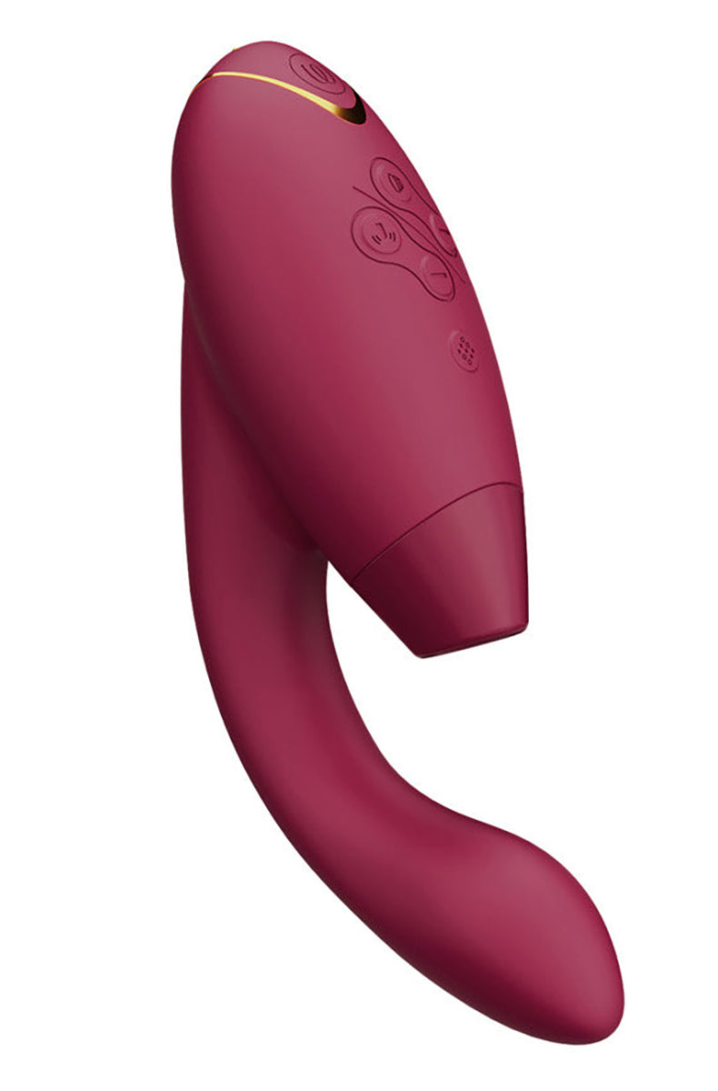 Side view of Womanizer Duo 2 in bordeaux red silicone with control panel and gold edge accent.