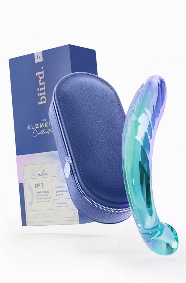 Iridescent glass Kalii dildo with its navy zippered case and Biird box, packaging noting borosilicate glass, on white.