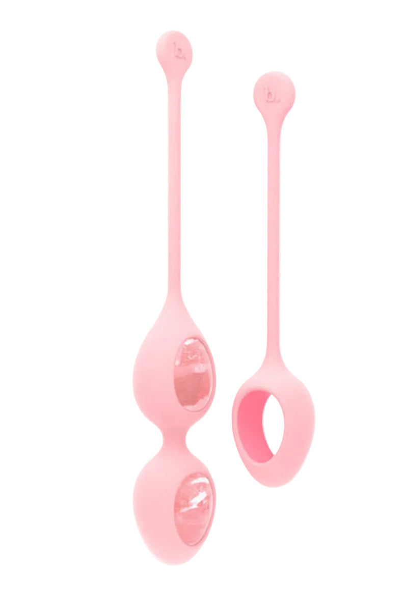 Two pink silicone holders with rose quartz eggs, a double-egg holder and a single holder with a pull loop, case badge.