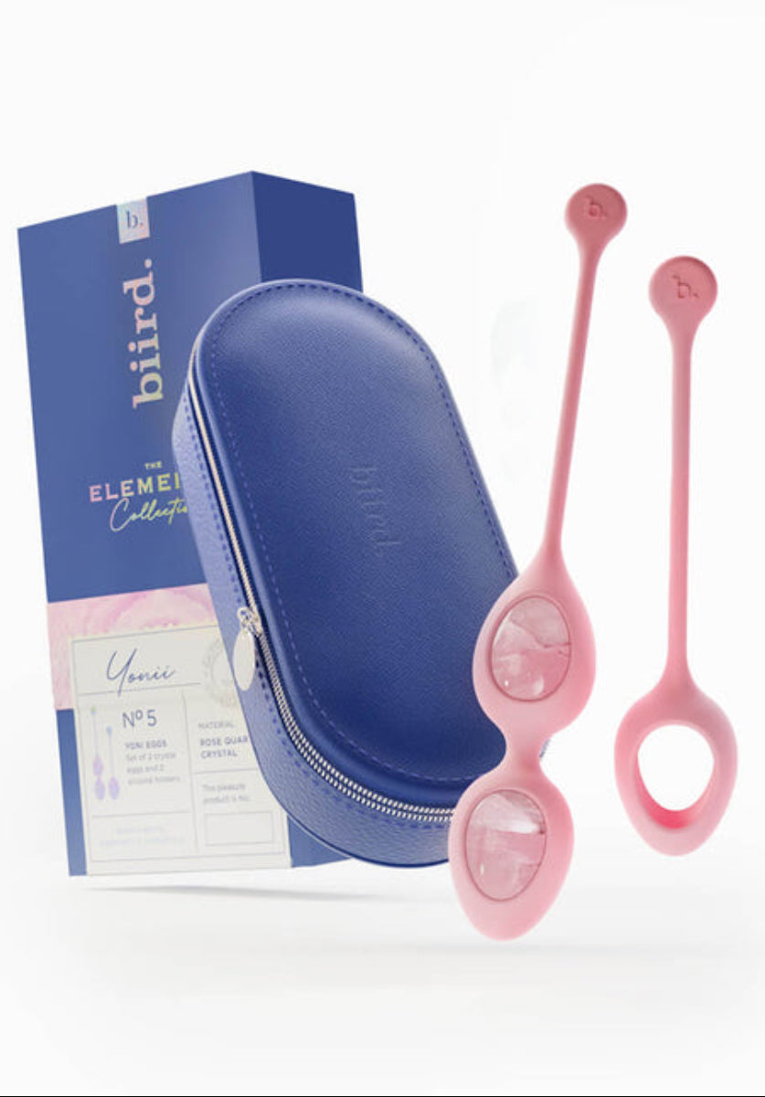 Rose quartz Yonii egg set with a navy vegan leather case and Biird box, packaging noting rose quartz crystal, on white.