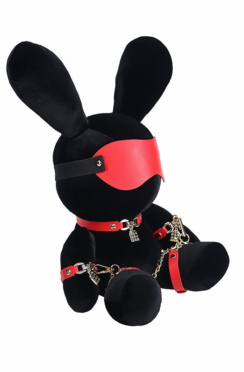 Side view of black velvet plush bunny showing red blindfold, padlock on red collar, and red ankle cuffs.