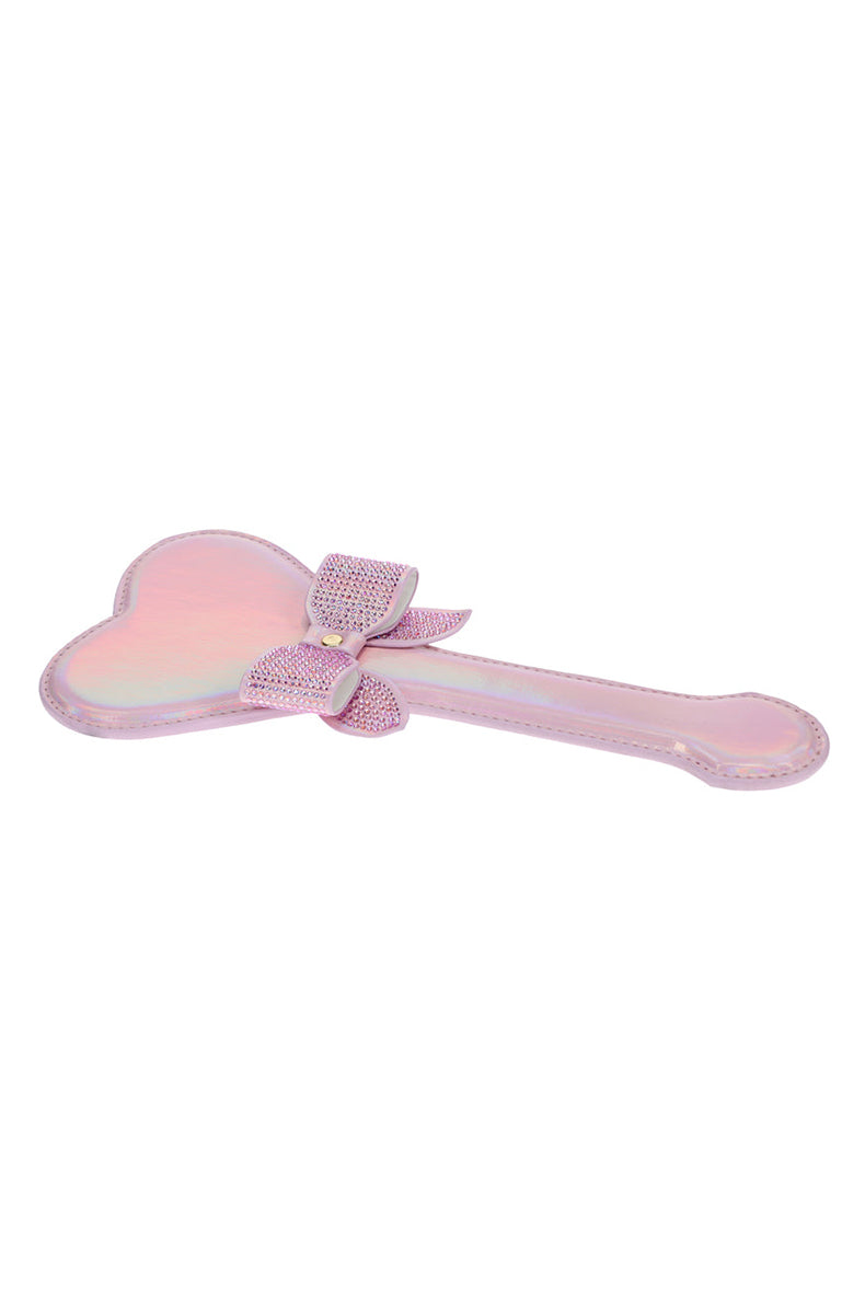 Detail view of the rhinestone bow with gold center stud against the pink iridescent heart head.