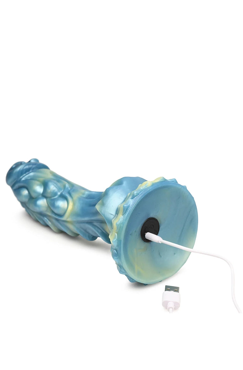 Bottom view of Sea Stallion dildo with USB charge port and cable next to suction base