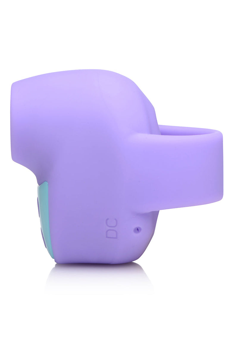 Angled view of purple Shegasm Mini air-pulse finger vibrator showing curved suction tip.