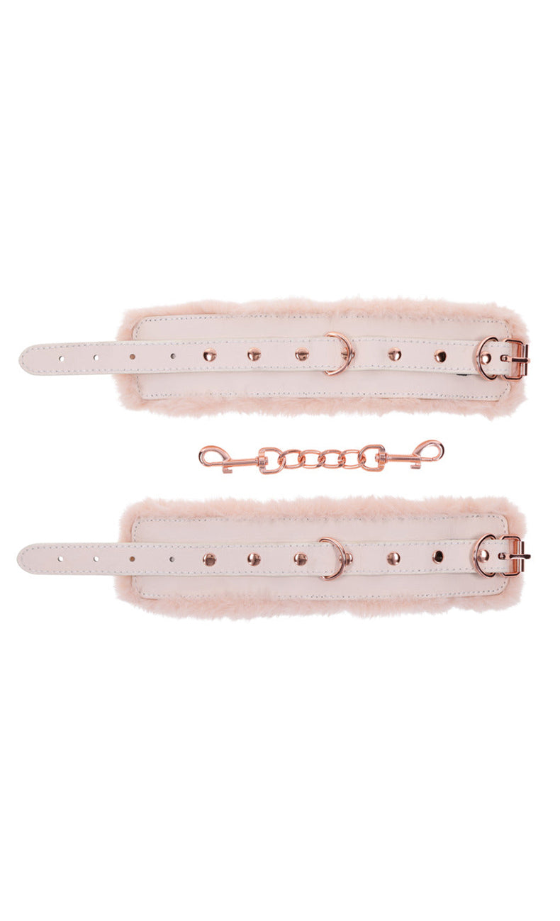 Flat layout of two cream faux leather cuff straps with peach fur and a separate rose-gold chain link.