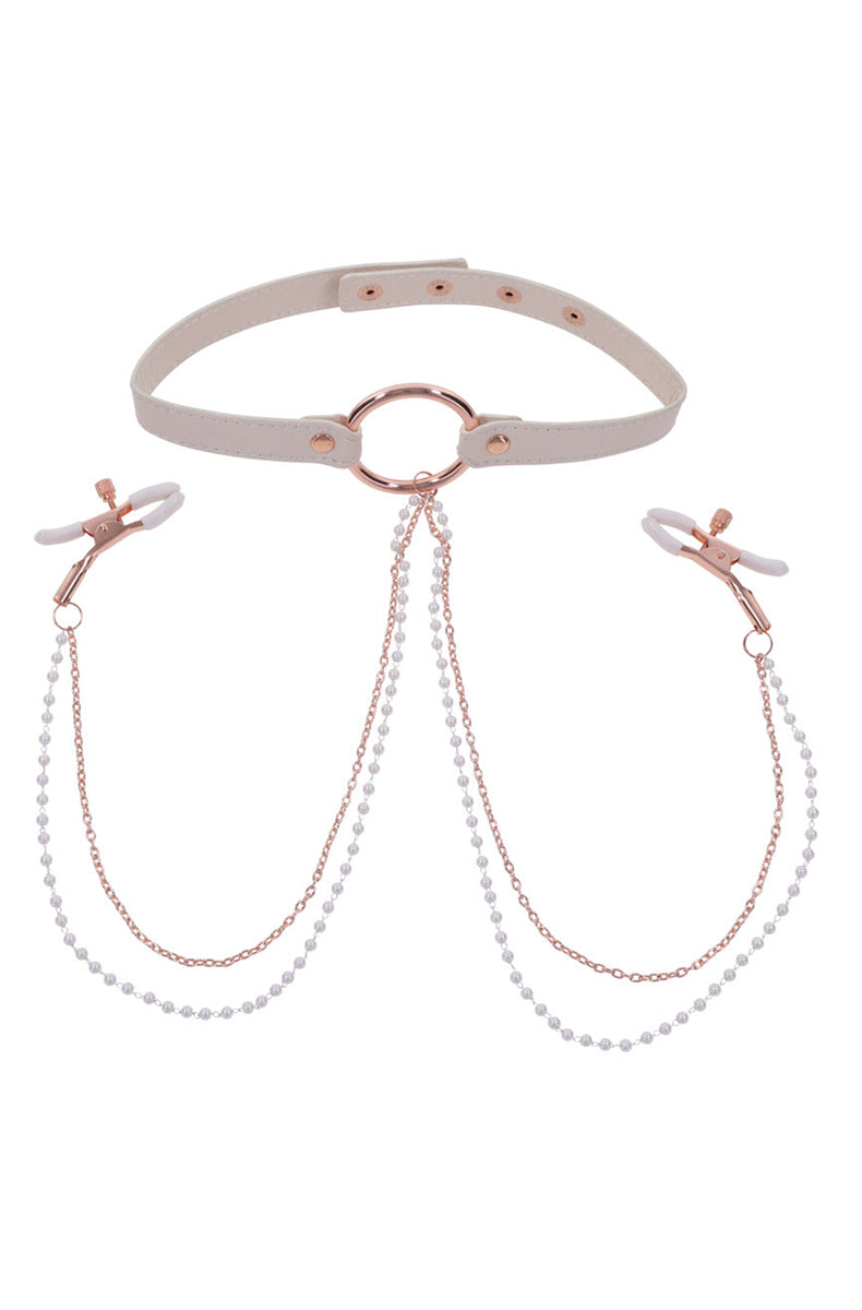 Close-up of dual rose-gold chains descending from the collar O-ring to the tweezer nipple clamps.