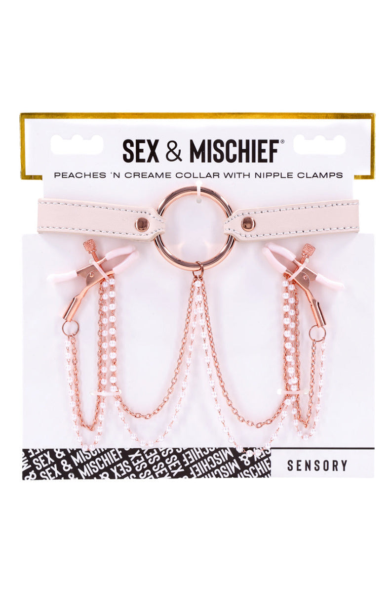 Detail view of white rubber-tipped rose-gold tweezer clamps at the ends of the collar chains.