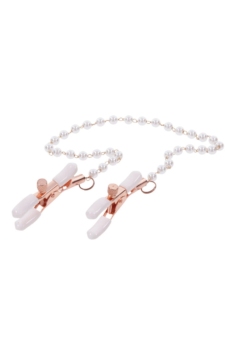 Detail view of faux pearl and rose-gold link chain connecting the two tweezer nipple clamps.