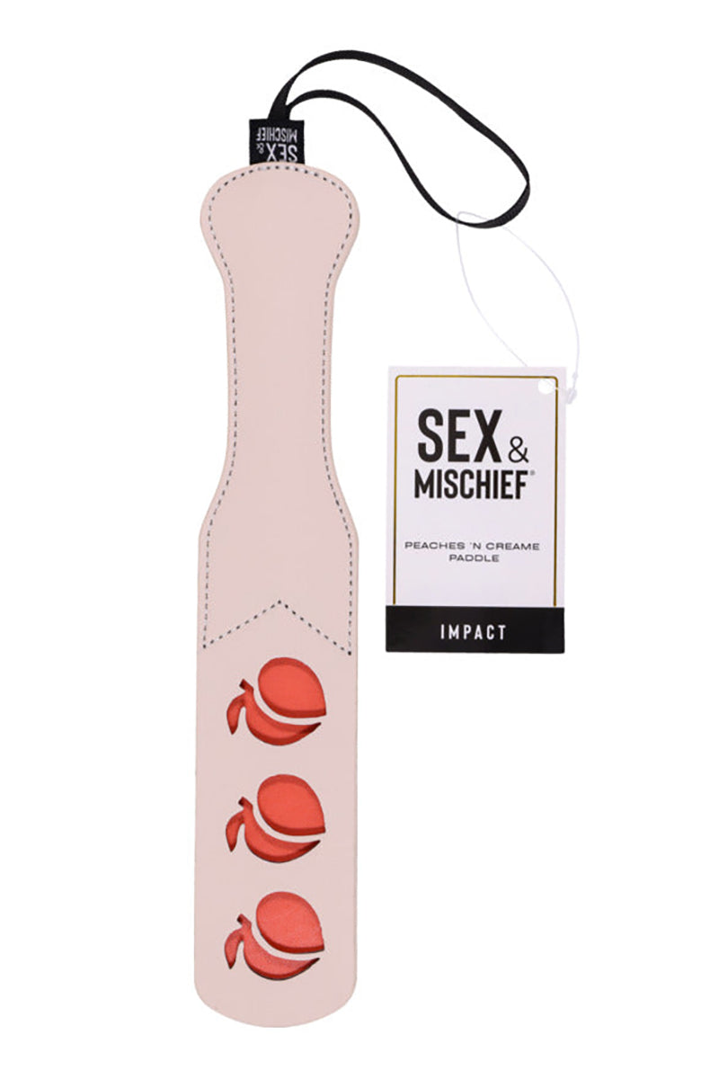 Front view of the cream paddle with a Sex and Mischief hang tag labeled Peaches N Creame Paddle Impact.