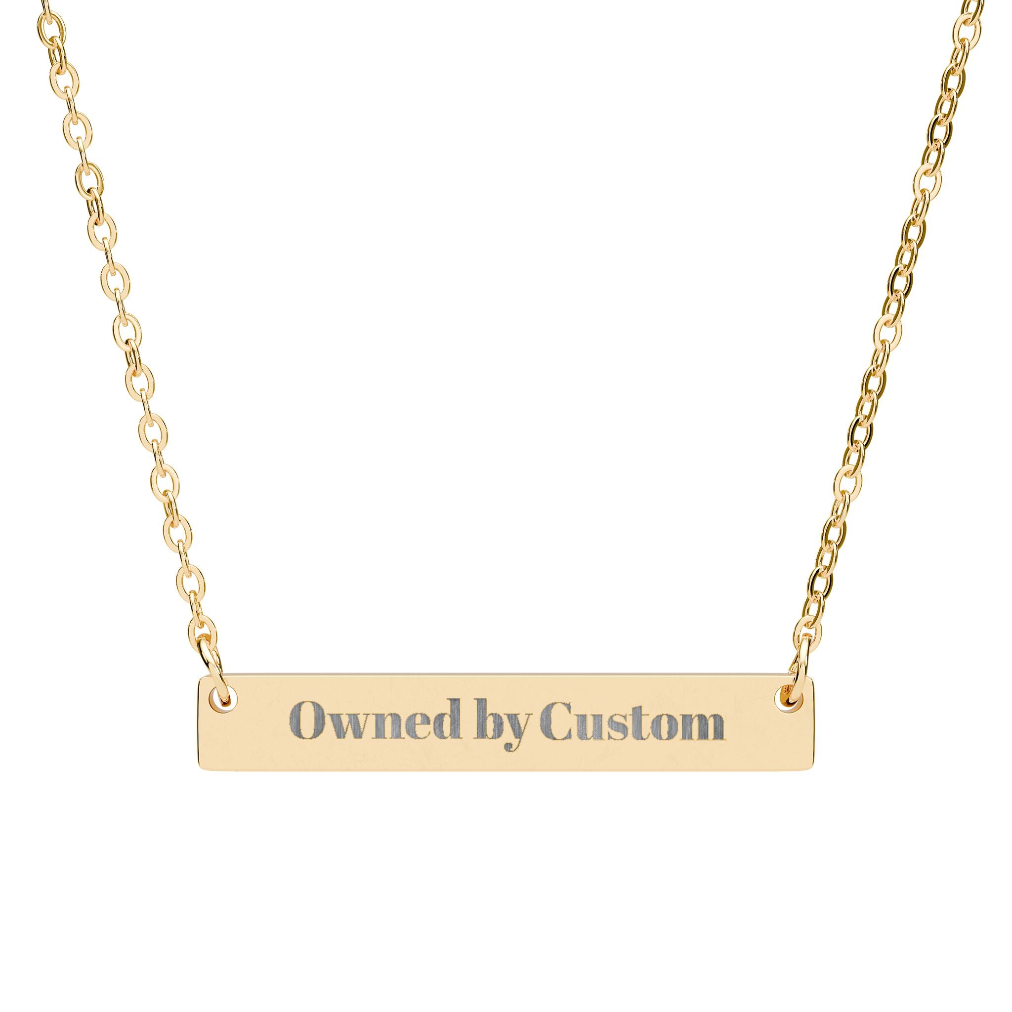 Gold necklace with 'Owned by Custom' engraving on a white background