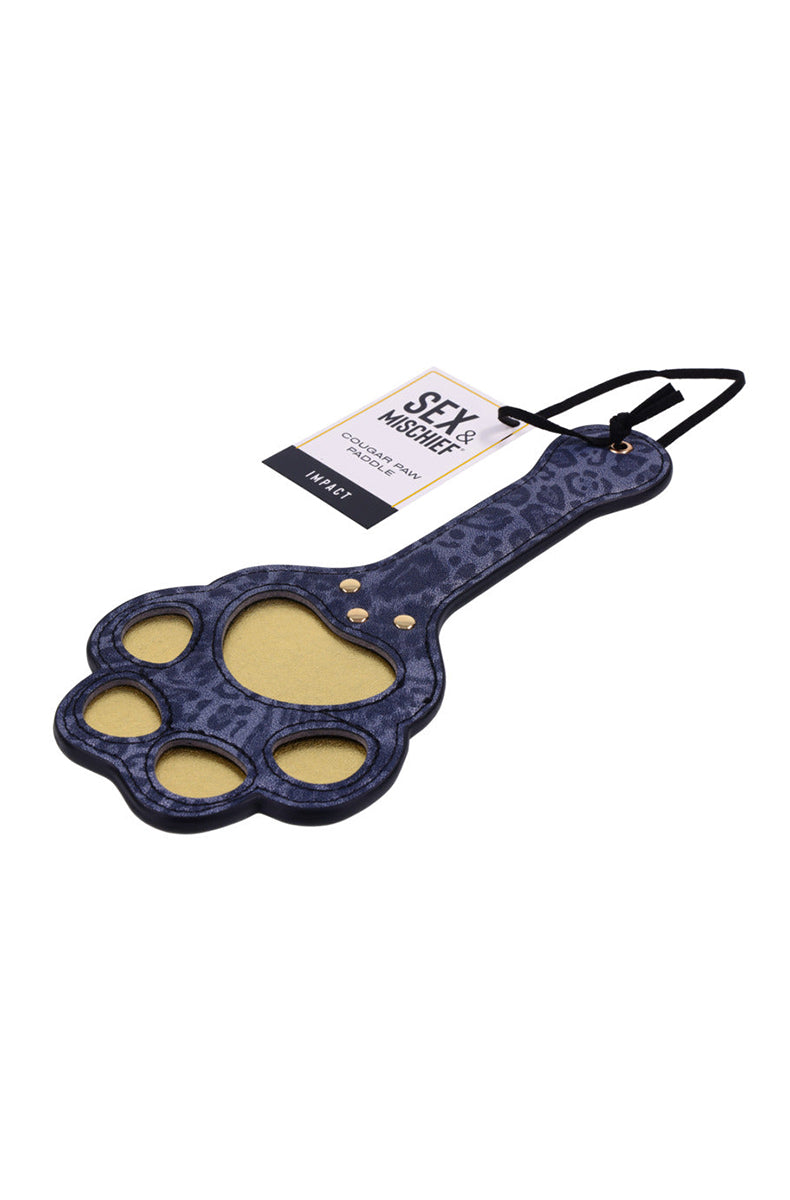 Angled view of the leopard-print paw paddle with gold pad cutouts and a Sex and Mischief Cougar Paw hang tag.