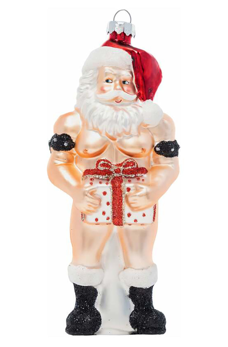 Hand-blown glass ornament of a shirtless muscular Santa holding a red and white polka-dot gift box at the waist.
