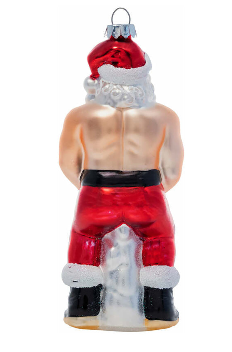 Side view of hand-blown glass Santa ornament showing red pants and two gold-glitter ornament balls.
