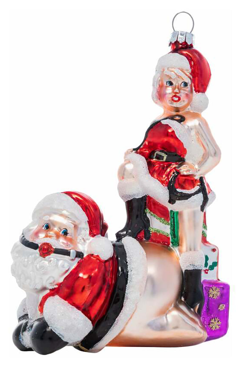 Hand-blown glass ornament of Santa Claus on hands and knees in red ball gag with Mrs. Claus standing on his back.