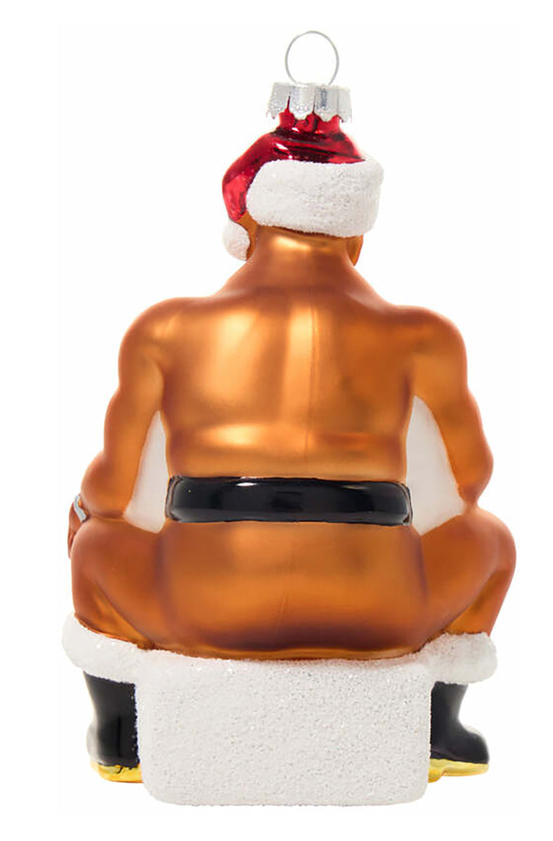 Side view of hand-blown glass ornament showing bearded man on snowy chimney with red sock detail.