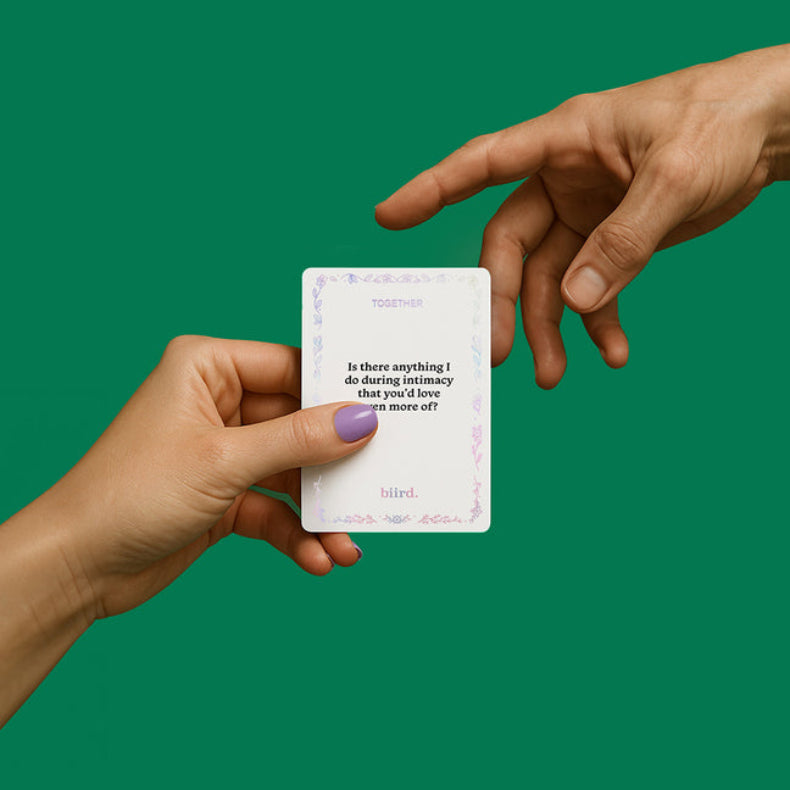 Biird Together intimacy prompt card passed between two hands