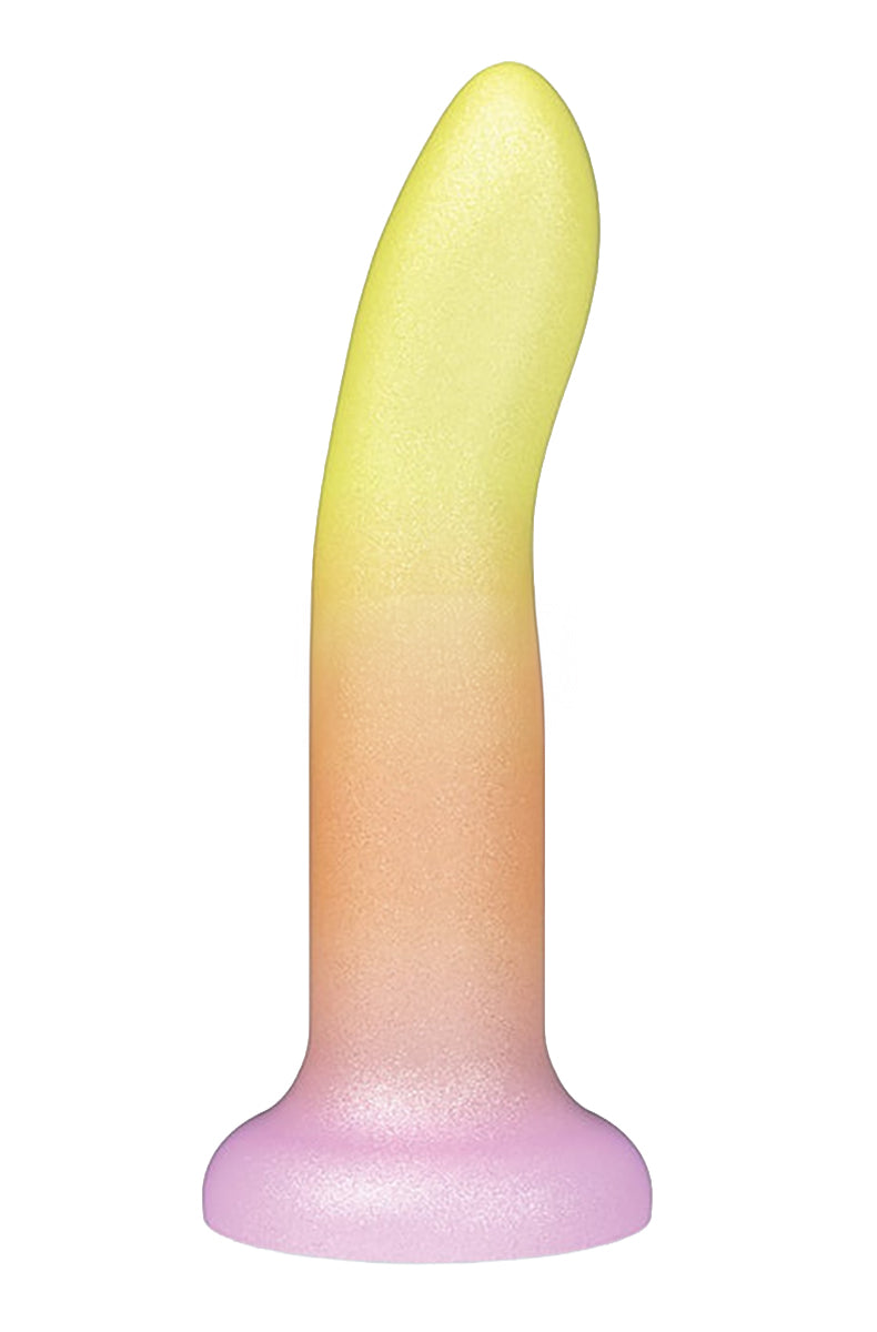 Shimmery silicone dildo fading yellow to orange to pink, gently curved on a suction cup base