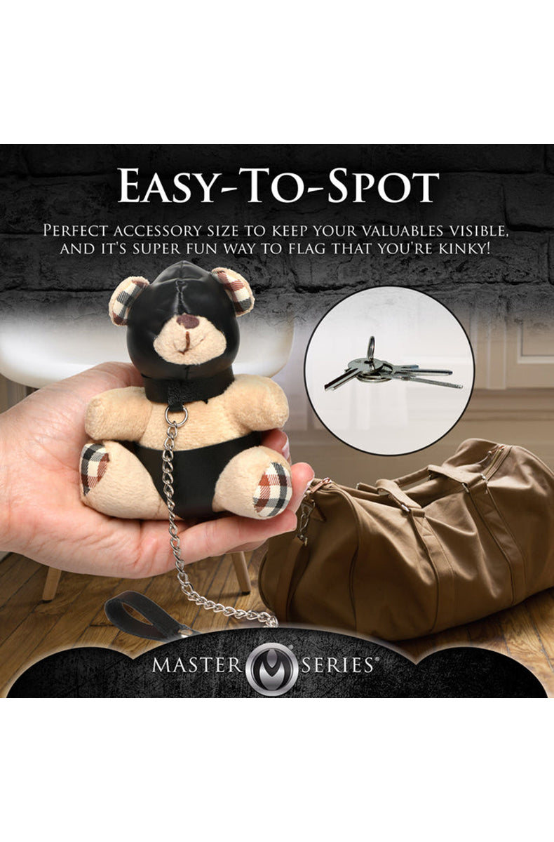 Detail view of silver chain leash and PU hand loop attached to tan plush teddy bear keychain.