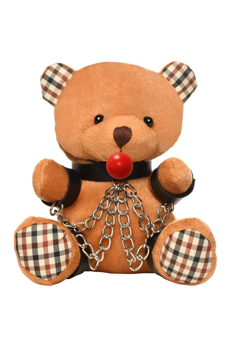 Tan plush teddy bear keychain in black collar, wrist and ankle cuffs with silver chains, red ball gag, and silver key ring.