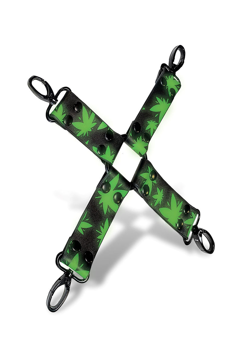 X-shape hogtie connector with bright green glow-in-the-dark cannabis-leaf print on black faux leather and black metal clips.