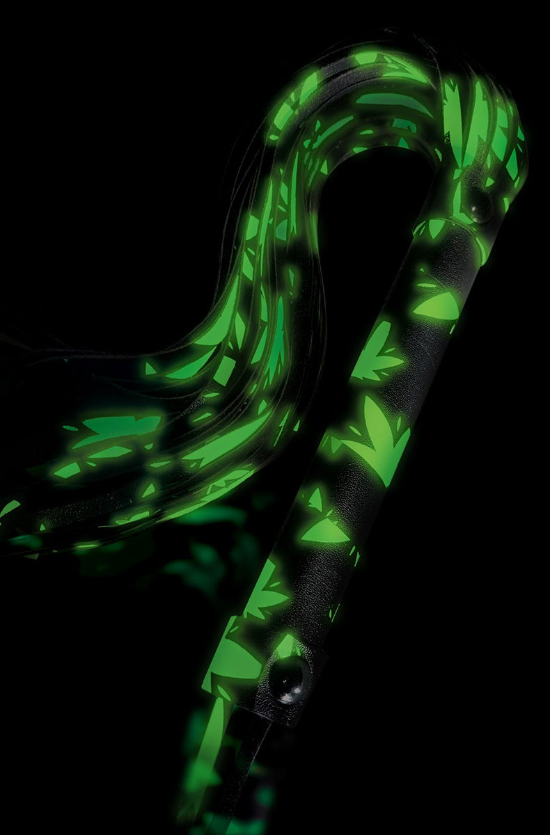 Glow-in-the-dark view of the leaf flogger lit up bright green against a black background, showing falls curving over.