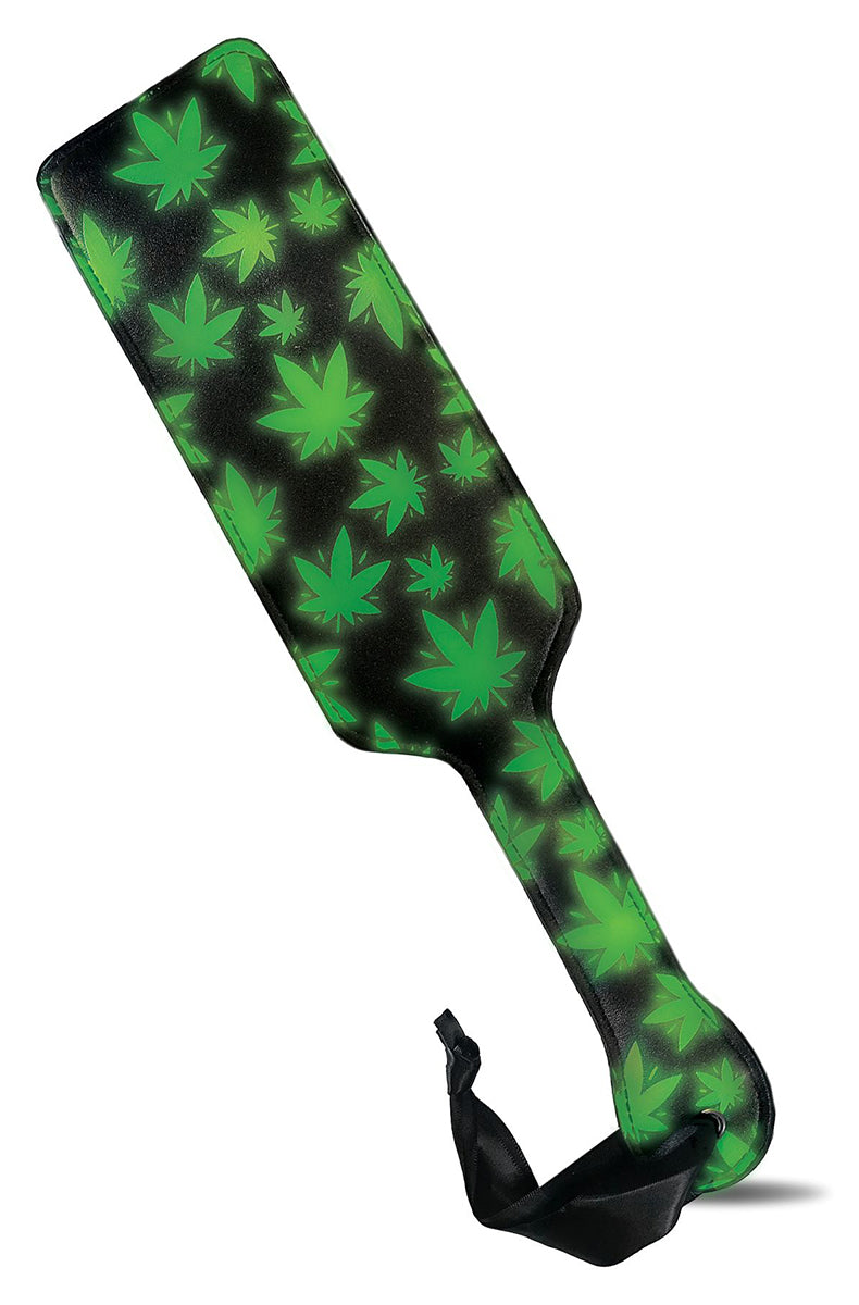 Long rectangular paddle in black with bright green glow-in-the-dark cannabis-leaf print and a black satin ribbon wrist loop.
