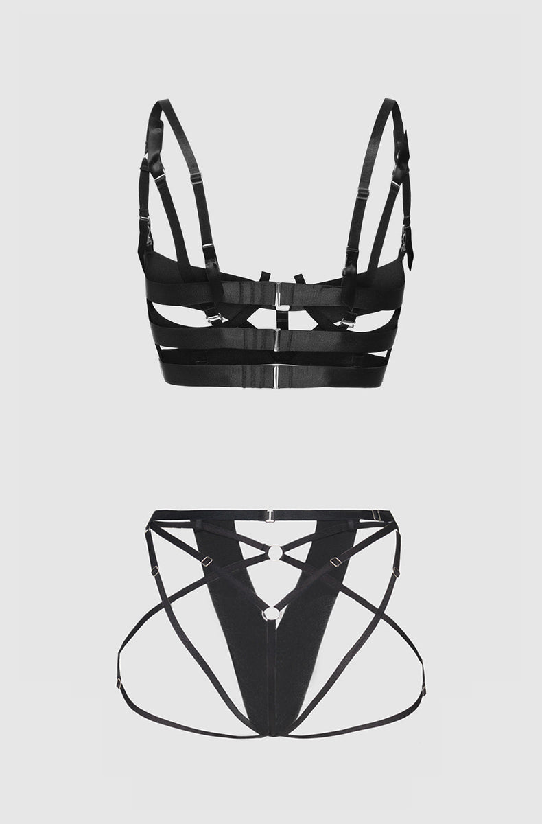 Black strappy bra and crotchless panty laid flat from the back