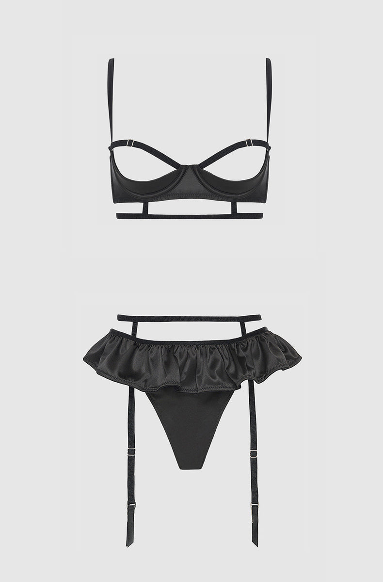 Black satin open cup bra and skirted thong with garters laid flat