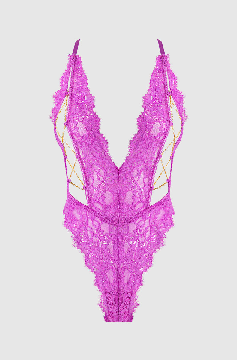 Fuchsia lace plunge bodysuit laid flat with crisscross chains
