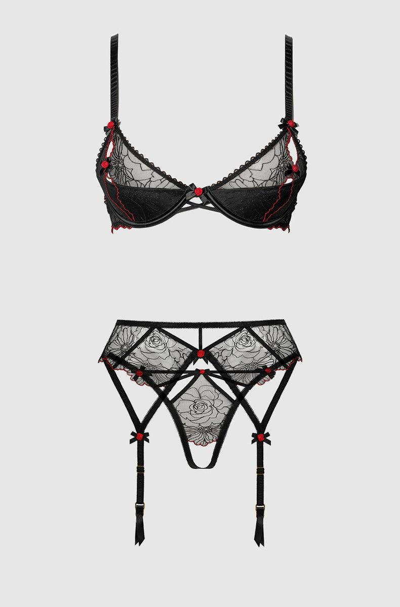 Black embroidered tulle bra and garter belt with panty laid flat