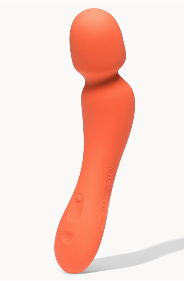 Front view of coral orange silicone wand vibrator with rounded flexible head and tapered handle