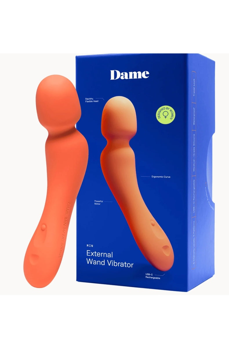 Coral wand vibrator next to blue Dame packaging box labeled External Wand Vibrator