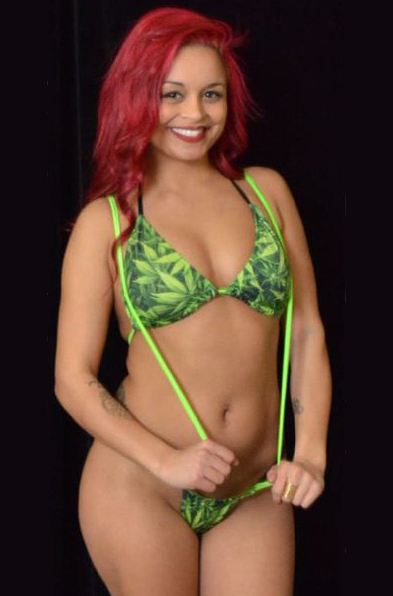 Cannabis-leaf-print sling-shot bikini set: triangle top and thong joined together by long neon-green stretch straps that loop over the shoulders and down to the thong.