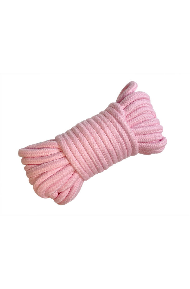 Bundle of soft pink woven bondage rope coiled and tied at the center on a white background.