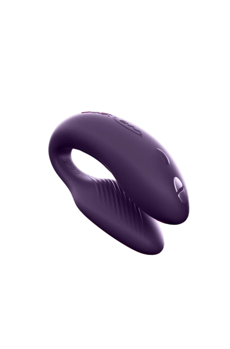 Side view of purple C-shaped vibrator showing curved design and ridged texture details