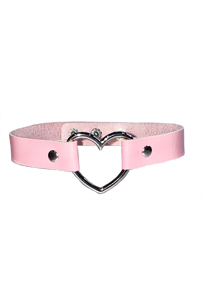 Close-up of pink faux-fur lined wrist cuffs with metal clasps and short chain.