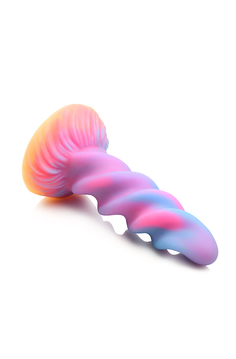 Spiral unicorn horn glow silicone dildo at an angle showing twisting ridges.