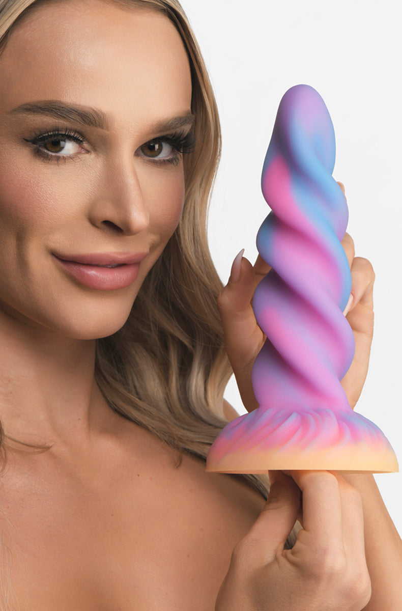 Front view of unicorn horn glow silicone dildo on flared suction base.