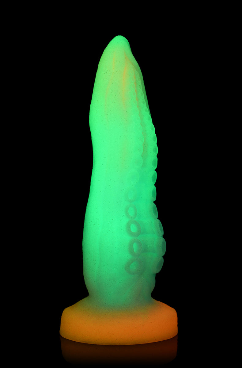 Side view of Glow Tentacle silicone dildo with rows of graduated suckers and ridges.