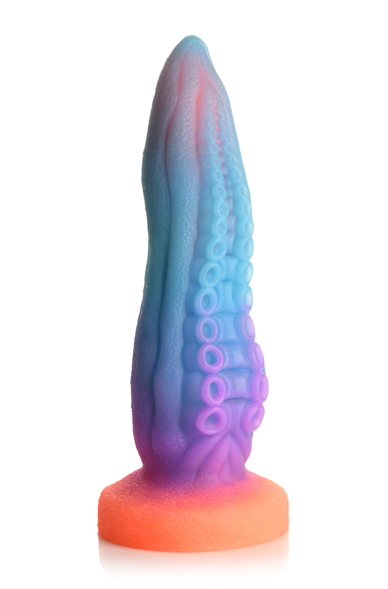 Glow silicone tentacle dildo, blue purple pink gradient, two rows of graduated suckers, orange flared suction base.