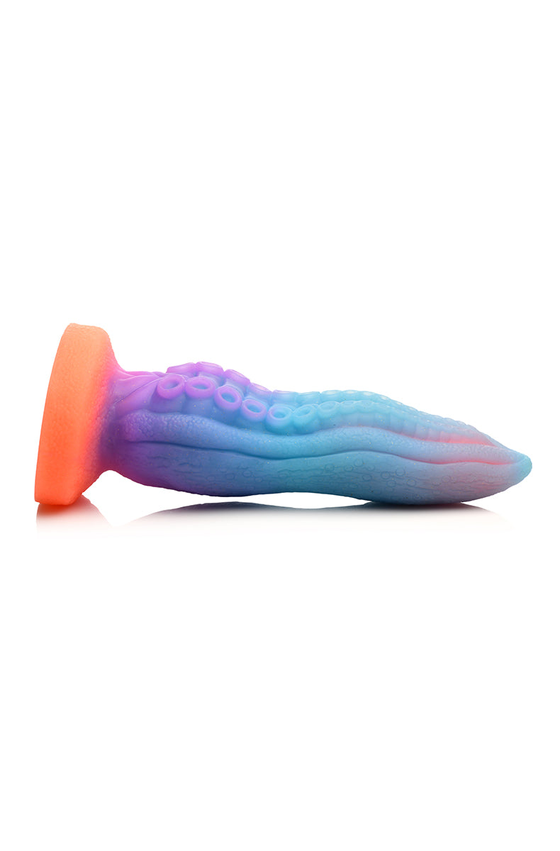 Rear view of Glow Tentacle silicone dildo with calloused ridges along the back of the shaft.