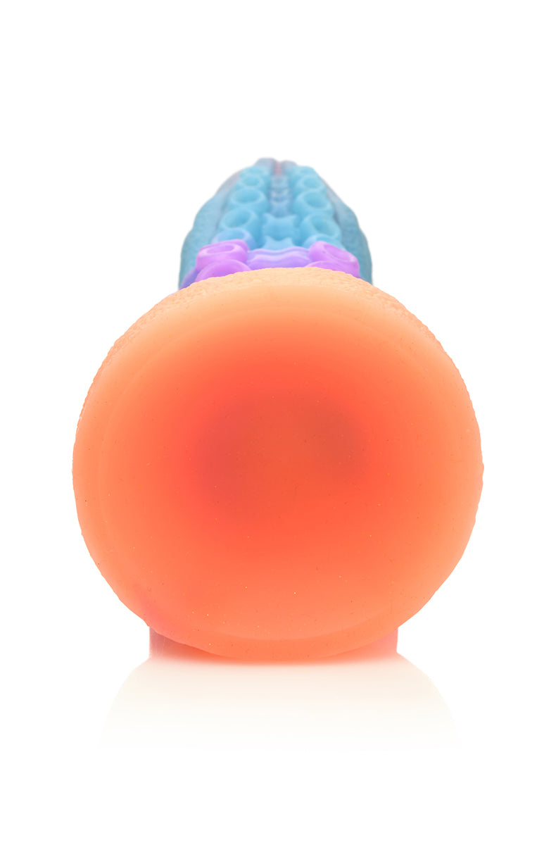 Glow Tentacle silicone dildo against white background, tapered tip and flared base.