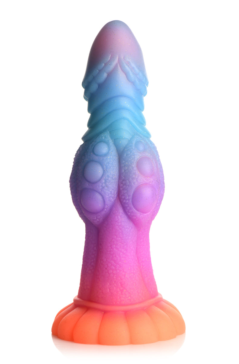 Pastel pink, purple, blue and orange glow silicone alien dildo with ridged head and bumpy shaft on flared suction base.
