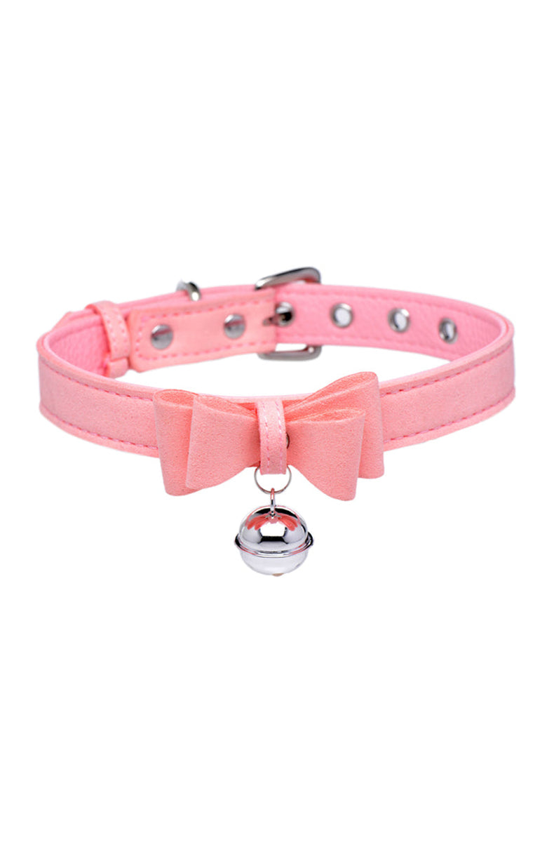 Pink suede-finish vegan leather collar with a small pink bow at the front and a silver jingle bell hanging below.