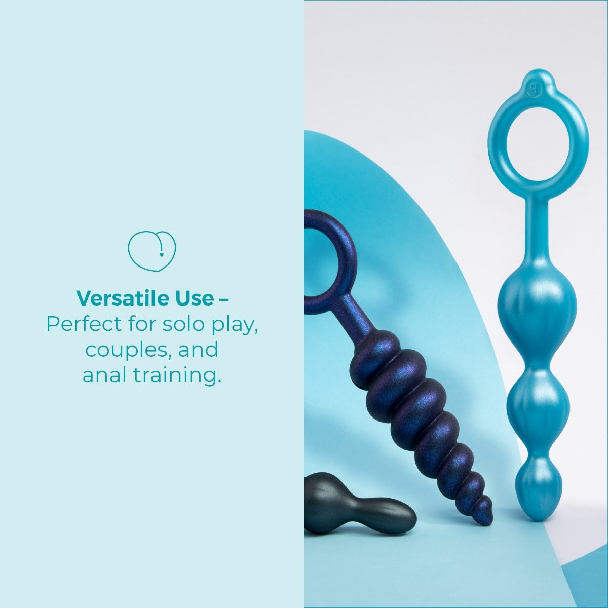 Lifestyle shot of the blue swirl and teal anal plugs propped on blue blocks with the black plug lying in front.