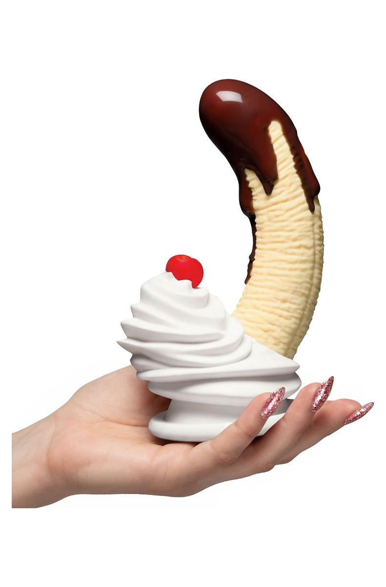 The dildo held in a hand for scale