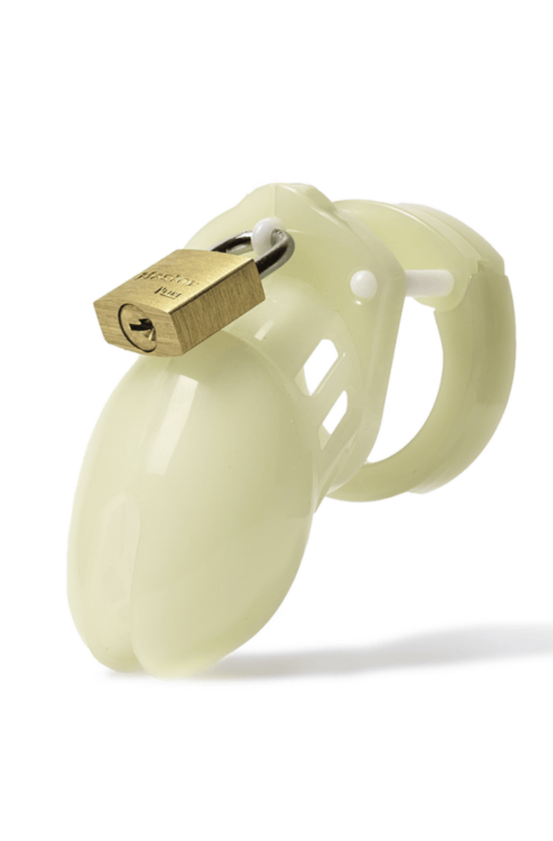 Pale green glow-in-the-dark CB-6000S chastity cage with a brass padlock, ventilated cage and ring, on white background.